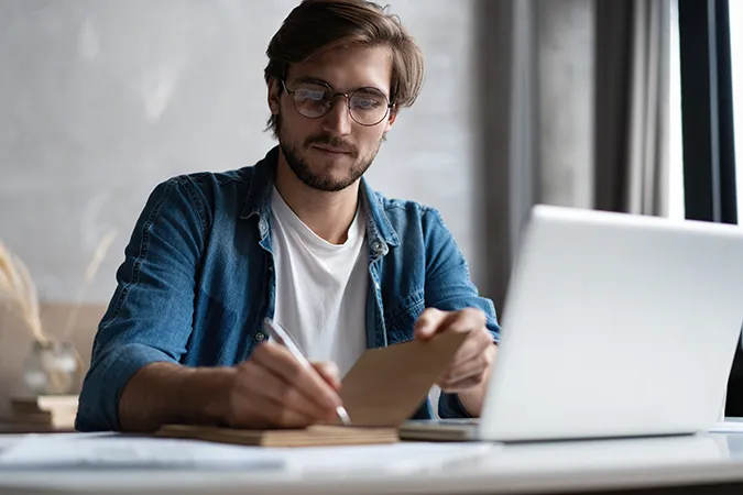 Man-With-Glasses-Taking-Notes_1937084866